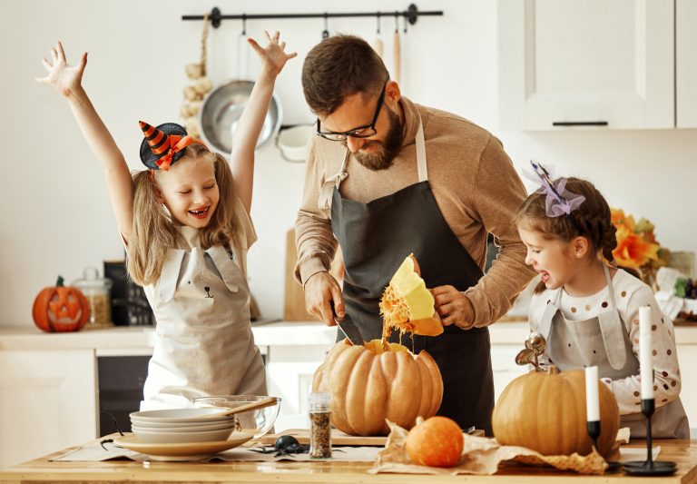 Family, Dad and daughters carving pumpkin