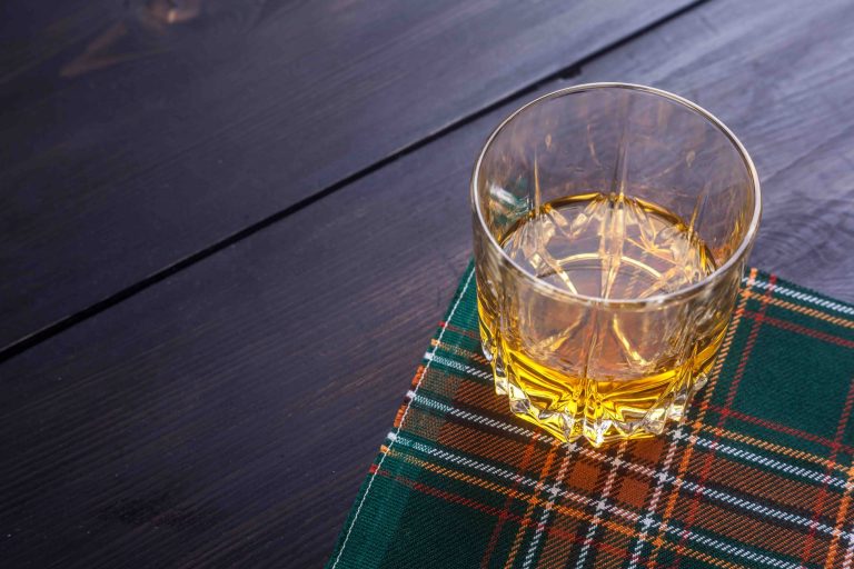 Whisky in a glass on tartan table cloth