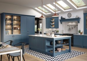 The Georgina shaker kitchen door in Airforce Blue is showcased in this kitchen design. This beautiful blue kitchen with an island, white worktops and gold handles. Tall larders and a mnatle above the oven and hobs looks traditional with modern twist in this kitchen design created by The Kitchen Depot