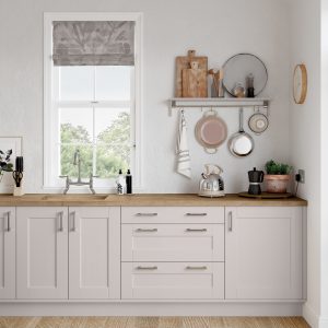 Run of Kendal Cashmere shaker cabinets and drawers featuring hanging pans, sink and kettle. Made by The Kitchen Depot