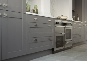 Kendal shaker kitchen drawers and cabinets in Dust Grey, made by The Kitchen Depot, alongside an oven.