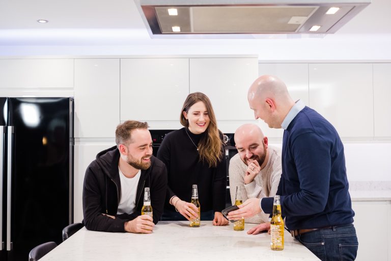 A group of friends spending time, socialising in the kitchen, the heart of the home