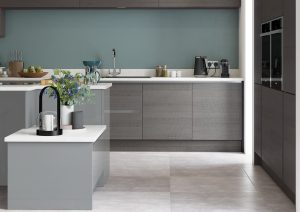 Zara Gloss Dust Grey Kitchen with white worktop, two tall oven units and a kitchen island. Designed by the kitchen depot