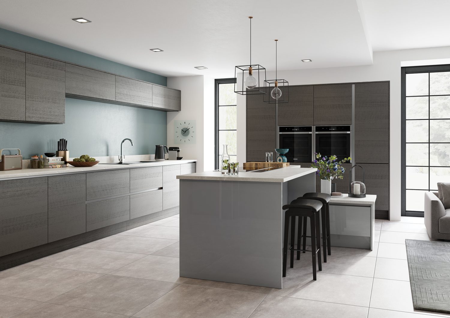 Zara Gloss Dust Grey Kitchen with white worktop, two tall oven units and a kitchen island. Designed by the kitchen depot. The Kitchen view is from the side of the island.