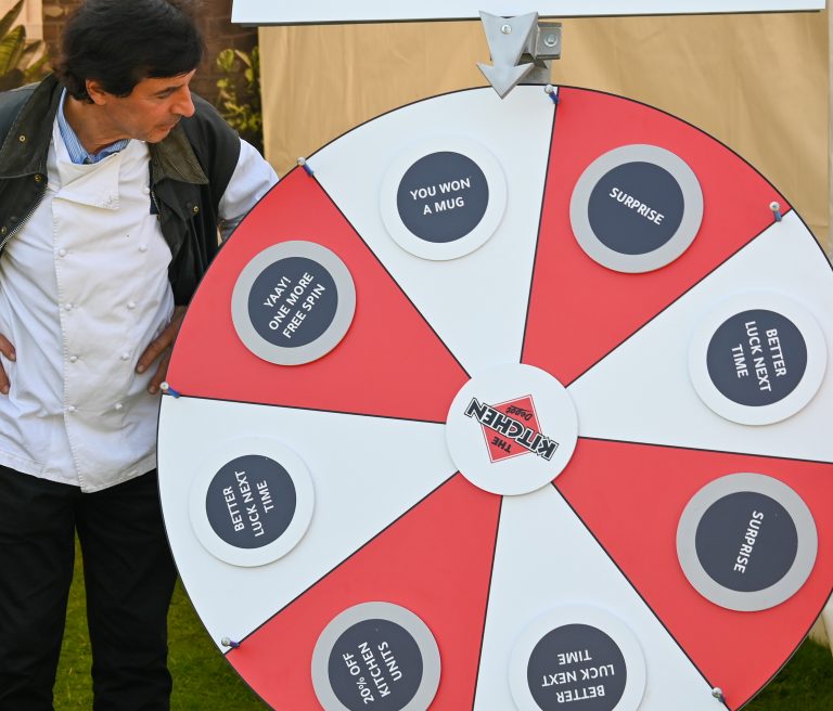 Jean-Christophe Novelli at The Kitchen Depot charity event playing the wheel of fortune game