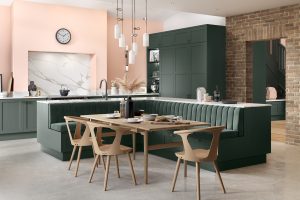 Alana Heritage Green shaker kitchen by The Kitchen Depot with seating area and wooden dining table. Kitchen Trends 2023.