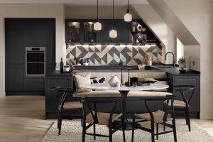 Hartford handleless graphite grey shaker kitchen made by The Kitchen Depot front view with dining table. Dark colour pallettes