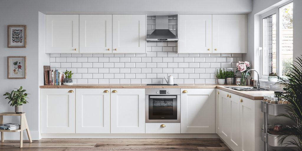 White Shaker Kitchen, with wooden worktops. Decorated with potted plants and a stainless steel oven and oven hood.