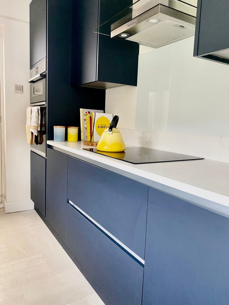 Handleless Indigo Blue doors and Carrara Quartz work surfaces.