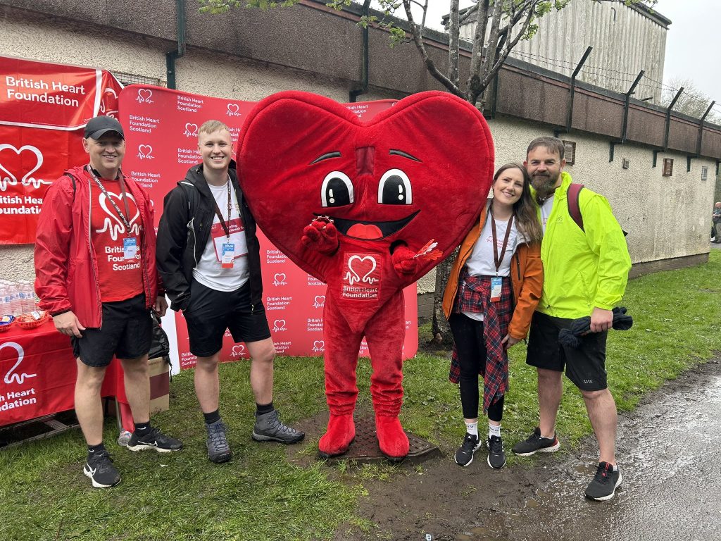 Mark McCay, Ross Craig, Siún Jordan, and Andrew Kinnaird from The Kitchen Depot pictured with The British Heart Foundation mascot at the Glasgow Kiltwalk 2023