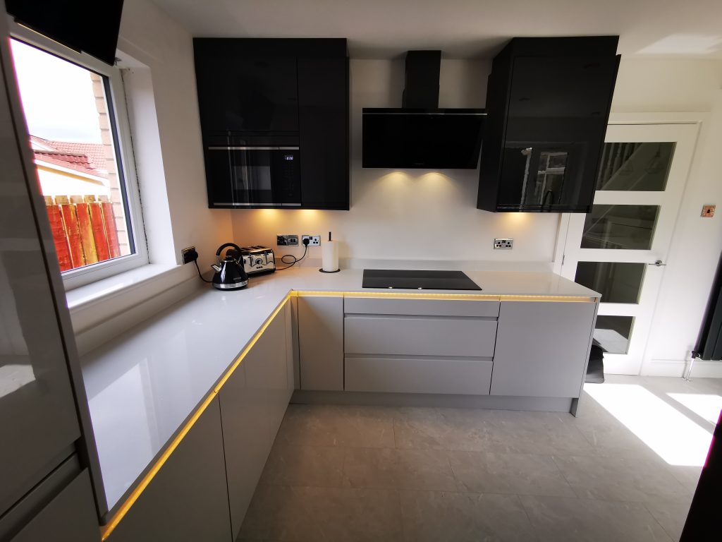 The Duncan's J-handle Light Grey & Graphite L-shaped kitchen with unique lighting by The Kitchen Depot