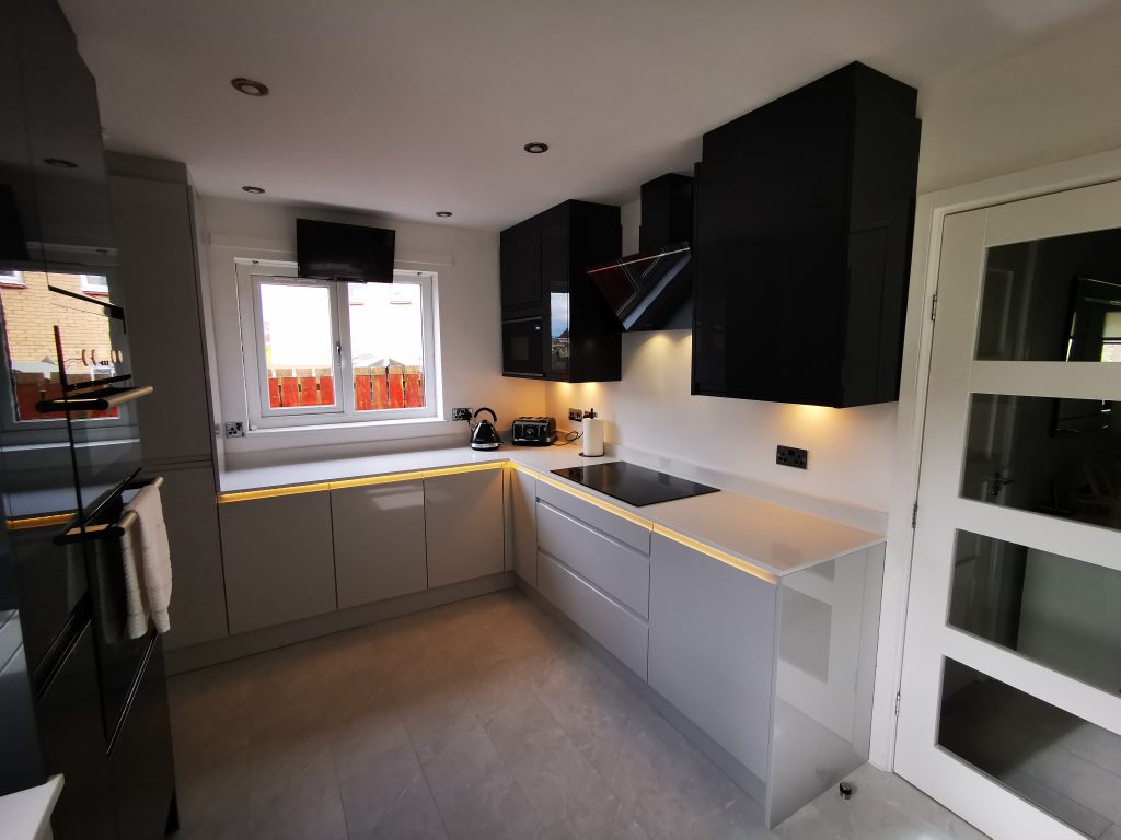 The Duncan's new dual tone design Light Grey & Graphite L-shaped kitchen with unique lighting by The Kitchen Depot