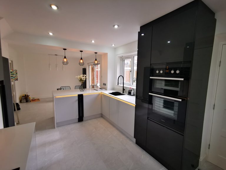 The Duncan's Light Grey & Graphite L-shaped kitchen with unique lighting by The Kitchen Depot