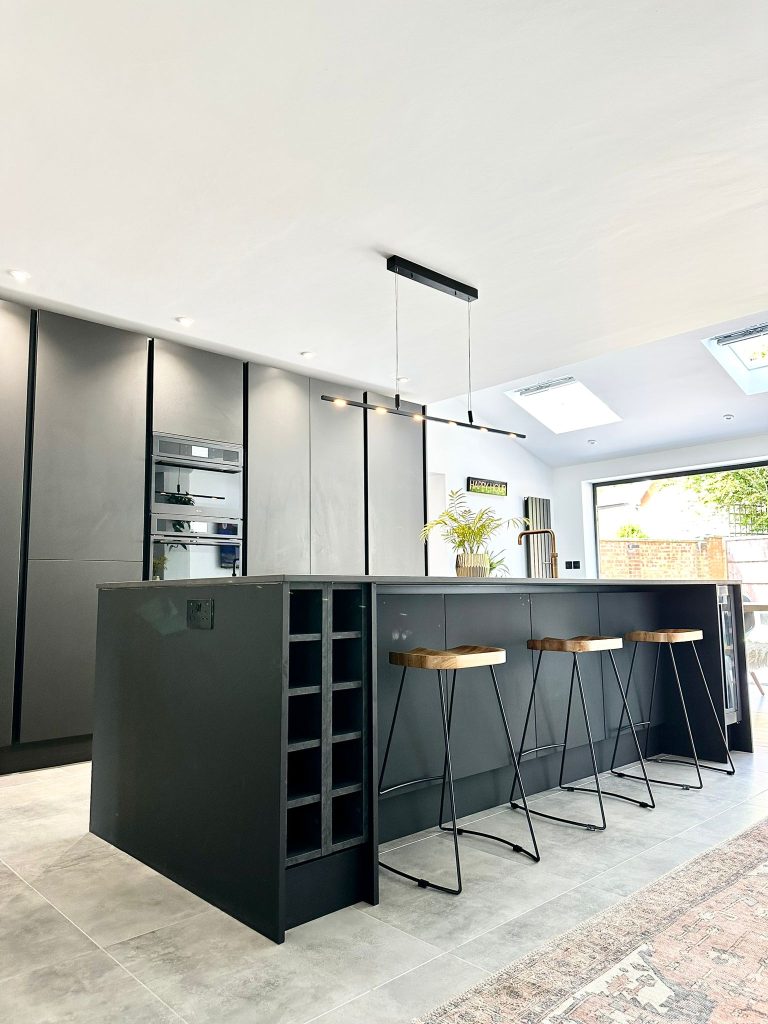The Setterfield's Matte Black Linea Kitchen featuring wine fridge and rack