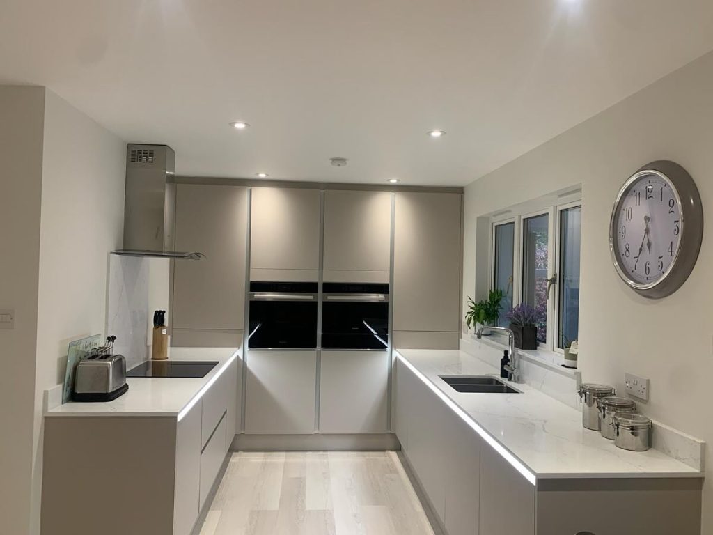 McQuat's Handleless Matte Cashmere Kitchen by The Kitchen Depot featuring Rocca Stone Quartz worktops