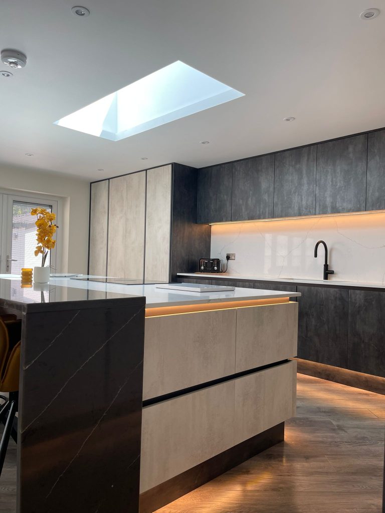 Side angle of the Midwinter's open plan kitchen featuring Linea White Chromix and Silver Metal Slate doors