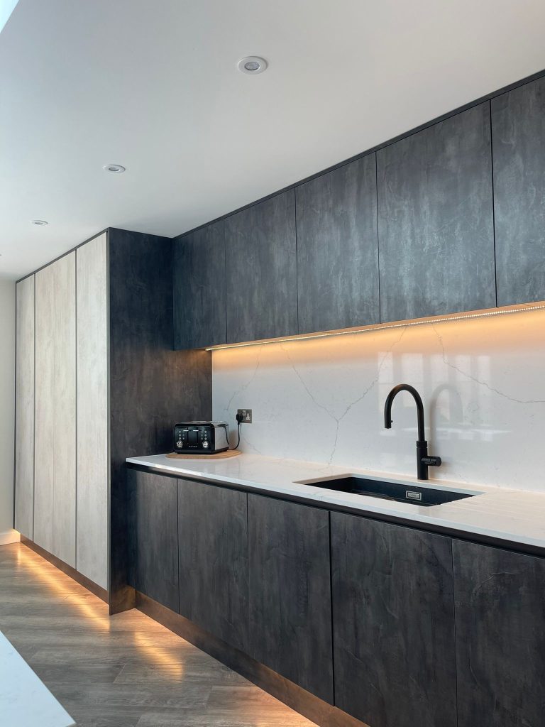 Run of units from the Midwinter's open plan kitchen featuring Linea White Chromix and Silver Metal Slate doors